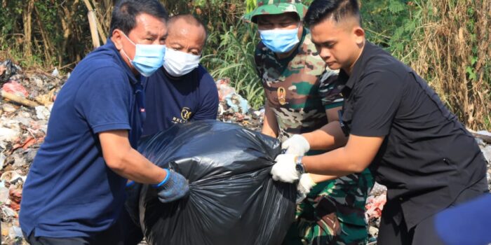 Bupati Tangerang Moch Maesyal Rasyid memakai kaos biru dan masker bersama TNI mengangkat kantong sampah hitam berukuran besar dalam kegiatan Jumat Bersih di Desa Tobat Balaraja pada 19 Juni 2026