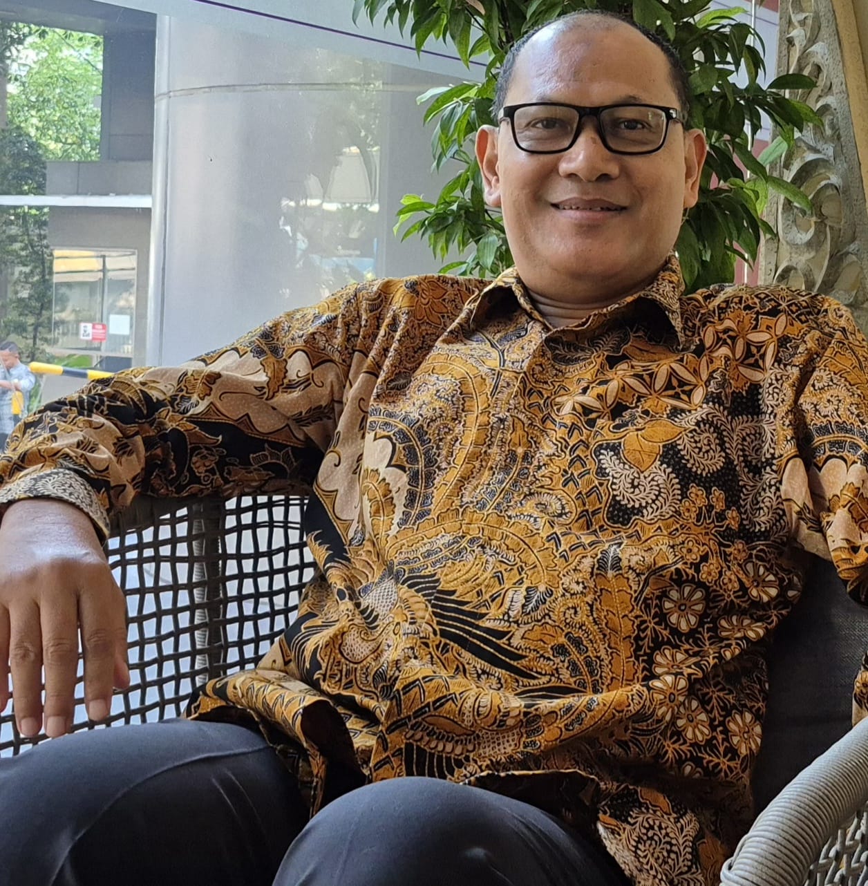 ekonom konstitusi defiyan cori pakai kemeja batik kacamata wawancara